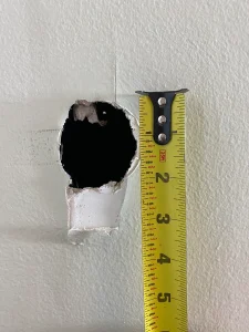 Measuring a wall hole to repair in North London