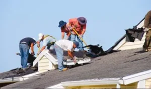Installing roofing tiles on North London house